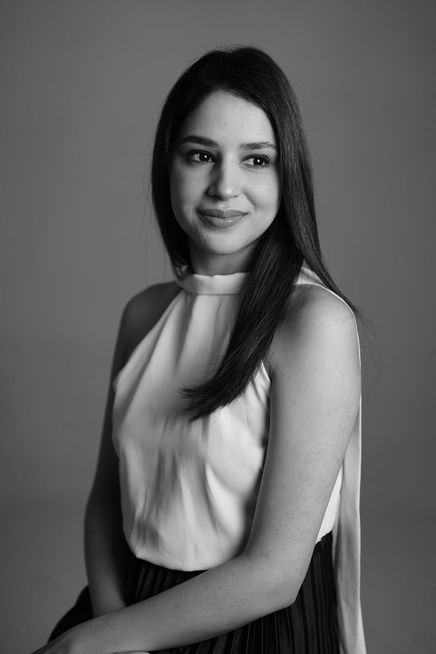Black and white portrait of a woman against a plain background