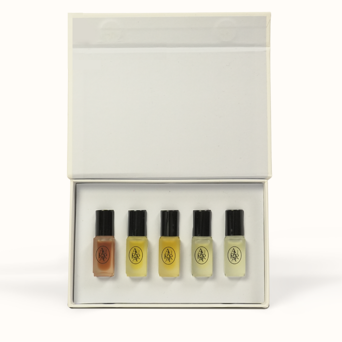 A boxed set of five small fragrance oil vials displayed in an open white presentation box on a clean white background.